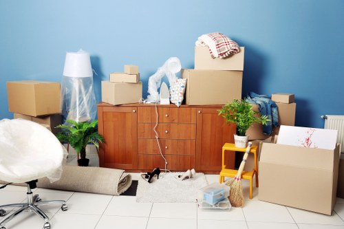 Removal team loading boxes and furniture for a move in Ladbroke Grove