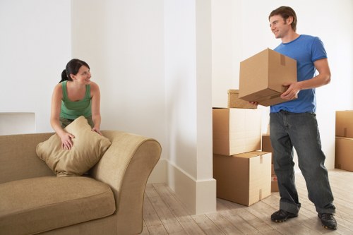 Professional movers handling office furniture and equipment for a local business move
